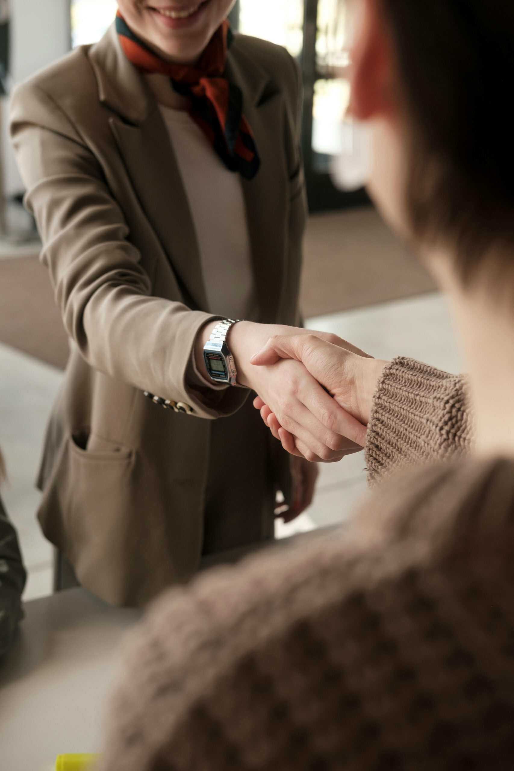 Close-up of a professional handshake indoors, symbolizing agreement and partnership.